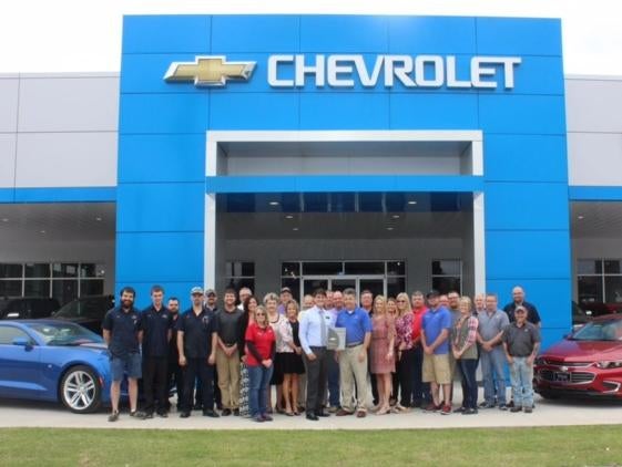 Hug Chevrolet staff in front of building